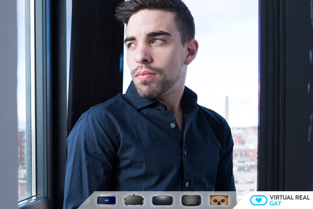 Image of fisting porn star Josh Milk. He is wearing a blue button up shirt and staring handsomely out the window